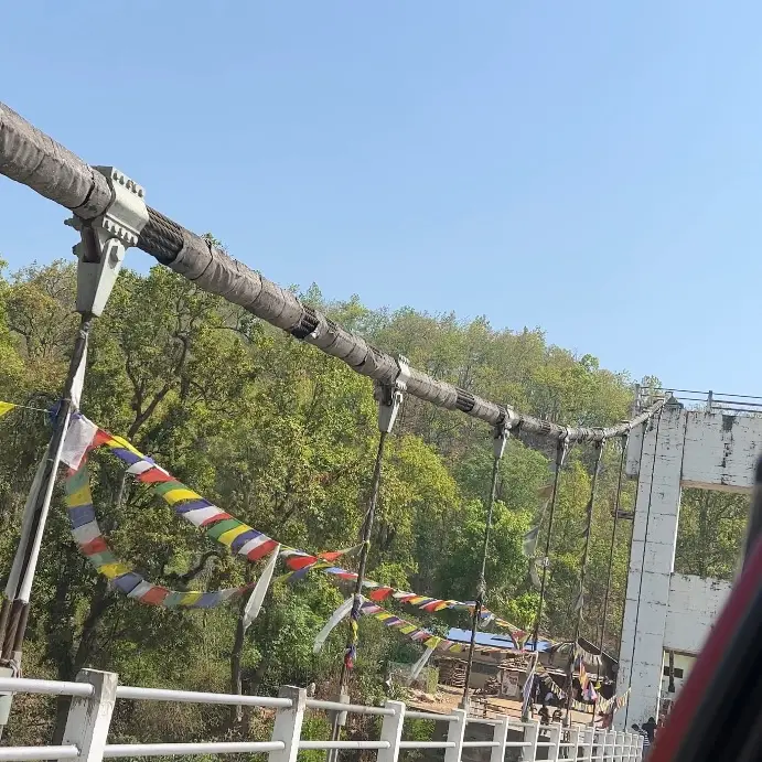 A suspension bridge hung with prayer flags